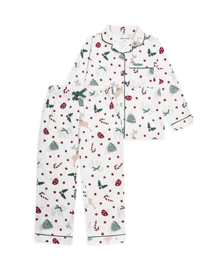A two-piece children's pajama set with a festive Christmas print, featuring a long-sleeve button-up top and matching pants on a solid white background.