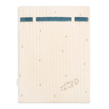 An off-white quilted fabric pad or sleeve with a blue horizontal stripe across the top and small gold embroidered details, shown flat against a white background.