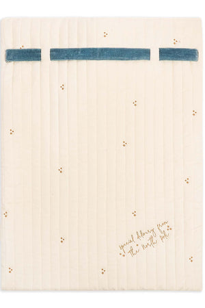 An off-white quilted fabric pad or sleeve with a blue horizontal stripe across the top and small gold embroidered details, shown flat against a white background.
