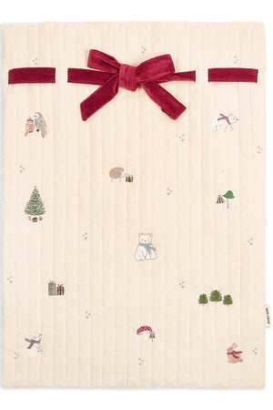 Beige fabric with Christmas-themed patterns and a red velvet bow on a white background