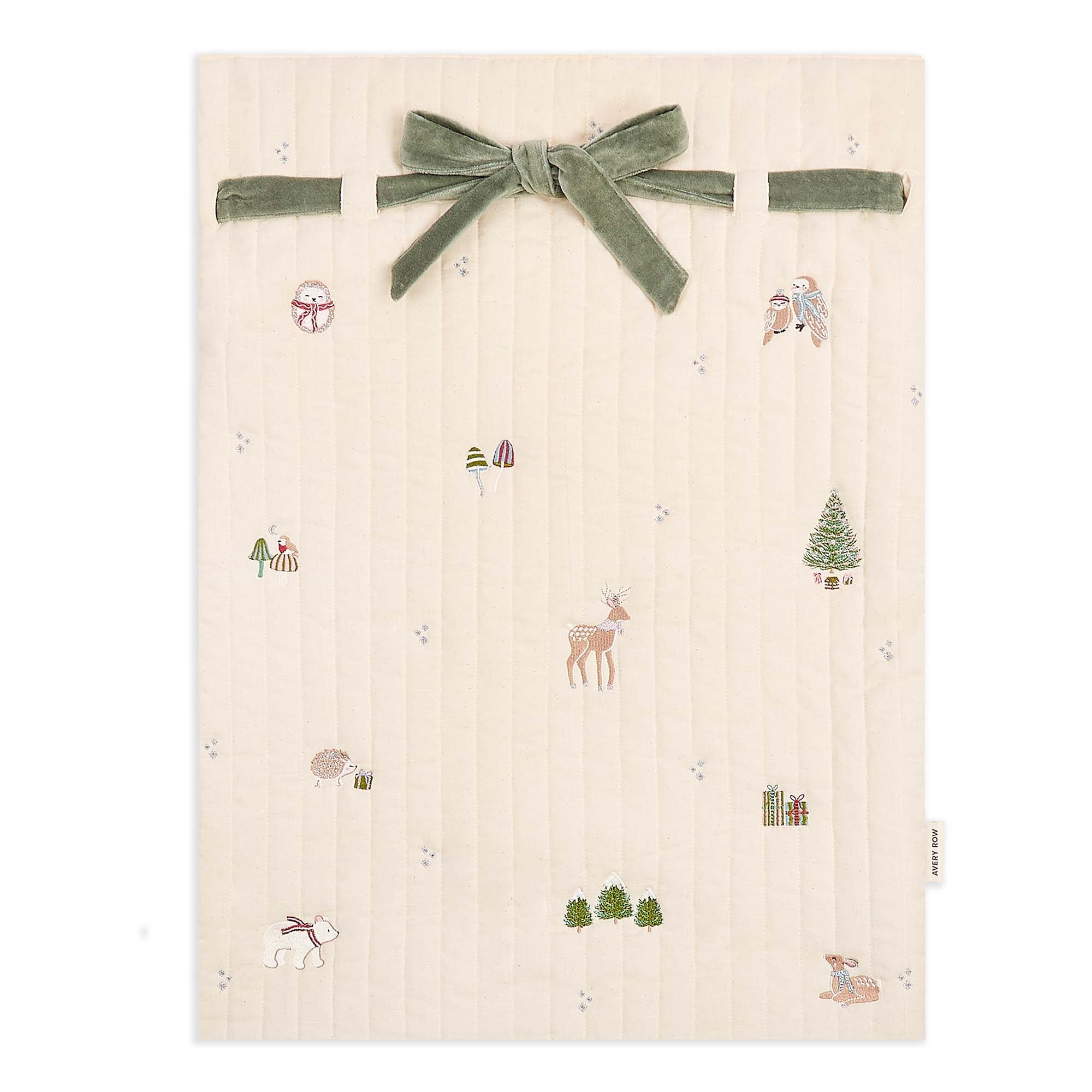Beige fabric with nature-themed embroidery and a green velvet ribbon on a white background