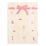 Baby blanket with embroidered designs and a pink velvet bow on a white background