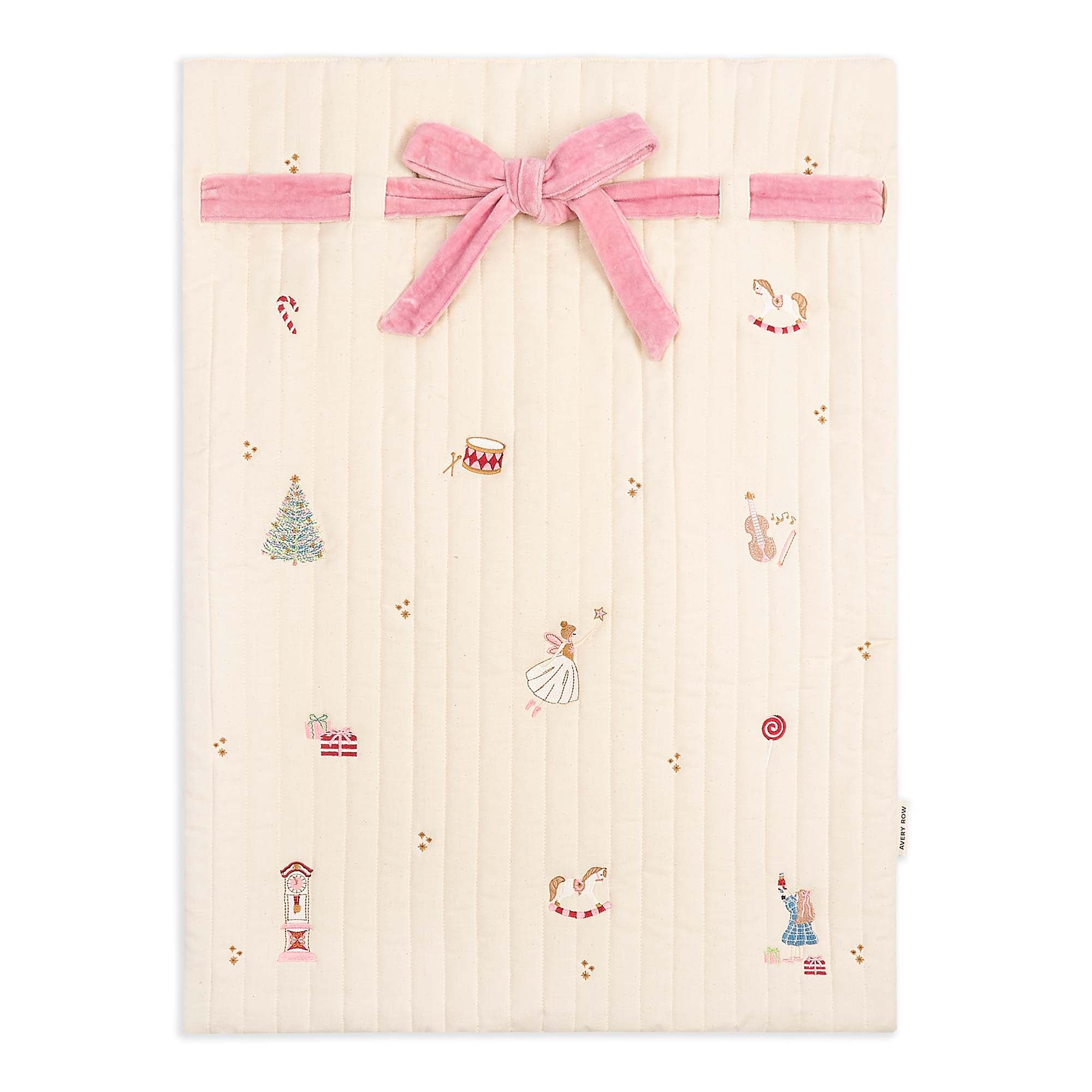 Baby blanket with embroidered designs and a pink velvet bow on a white background