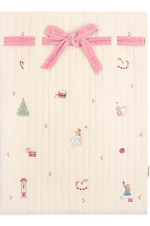 Baby blanket with embroidered designs and a pink velvet bow on a white background