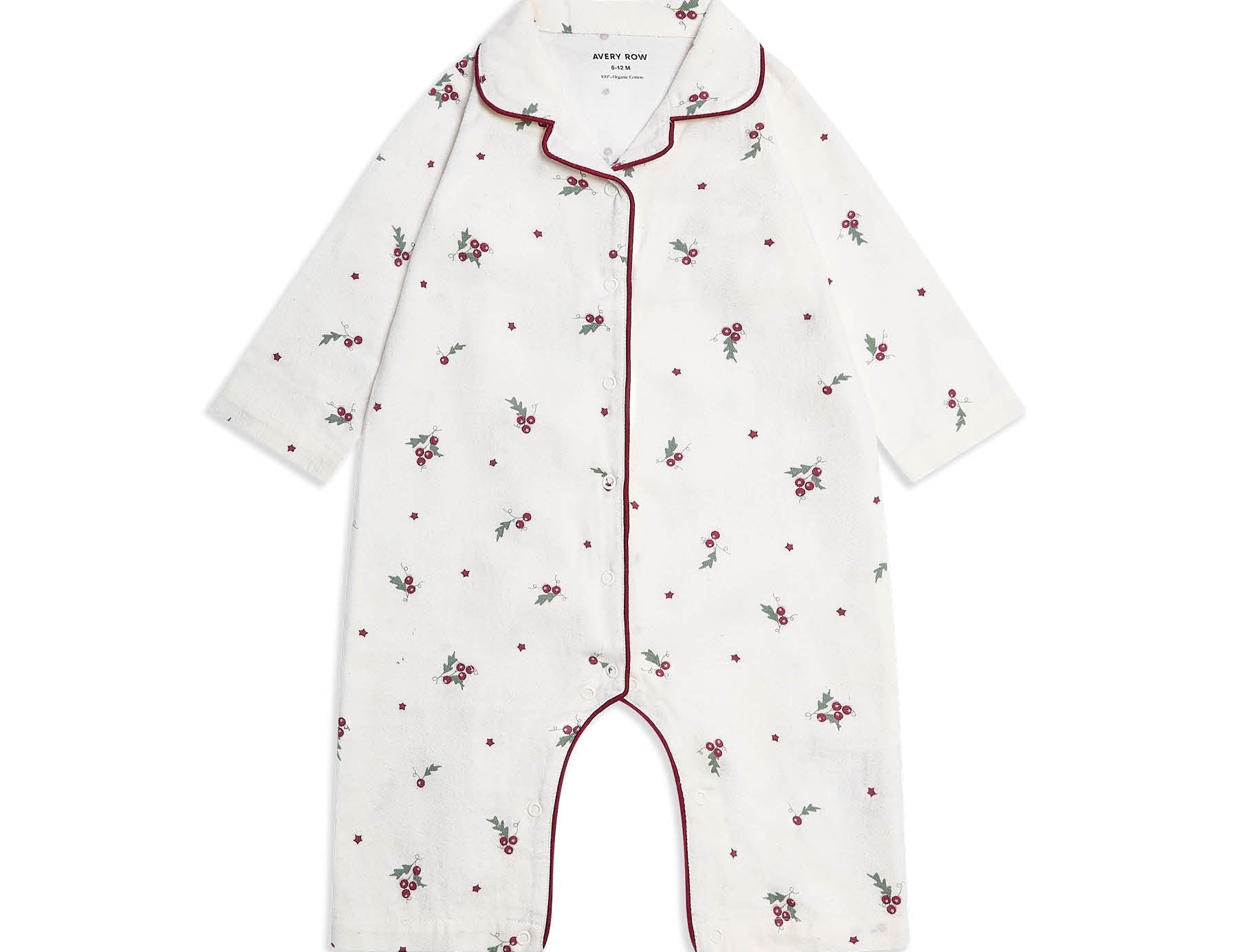 A baby long-sleeve footless romper in white cotton, decorated with a small red and green floral and dot pattern, featuring red piping along the collar, front placket, and leg openings.