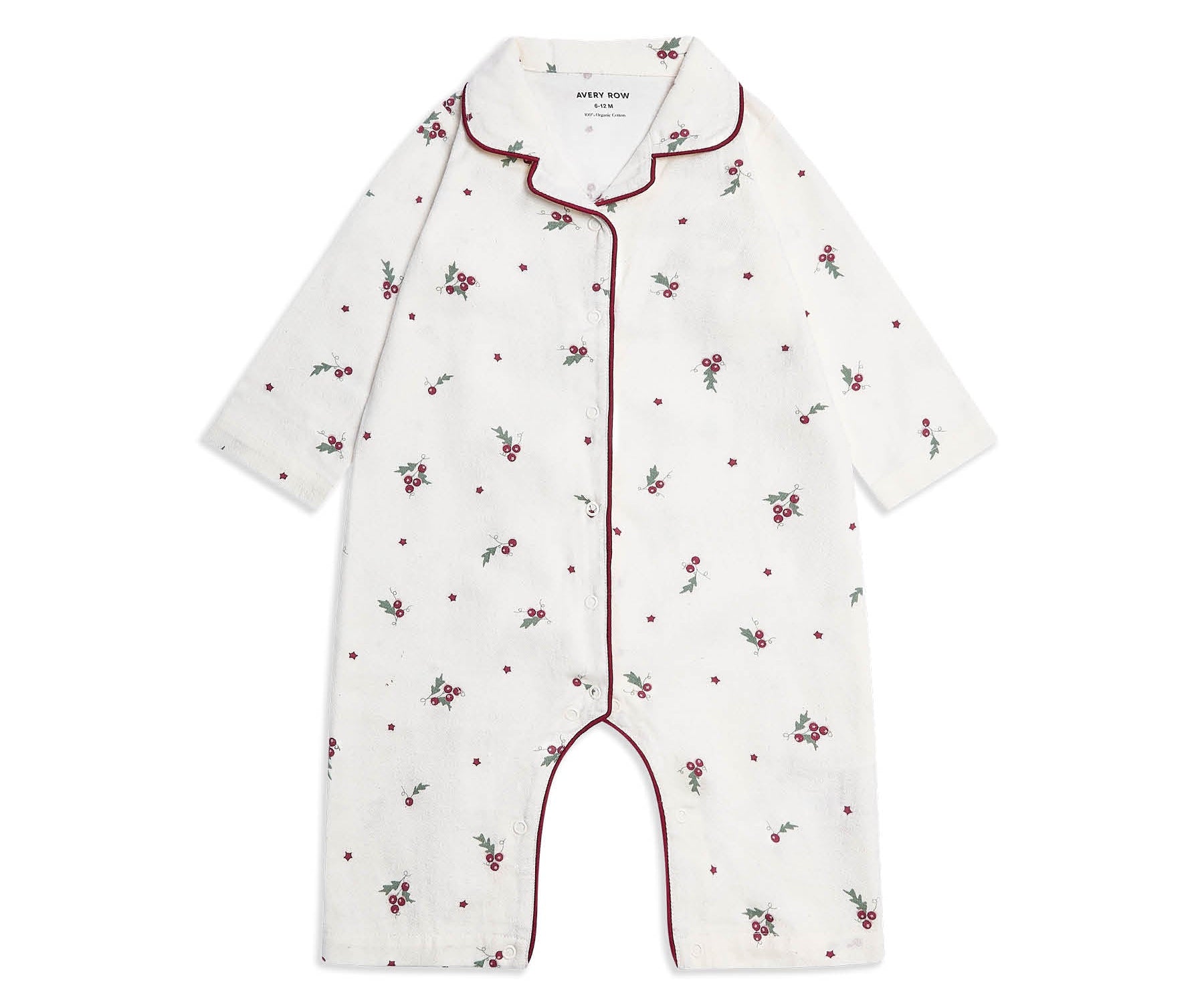 A baby long-sleeve footless romper in white cotton, decorated with a small red and green floral and dot pattern, featuring red piping along the collar, front placket, and leg openings.