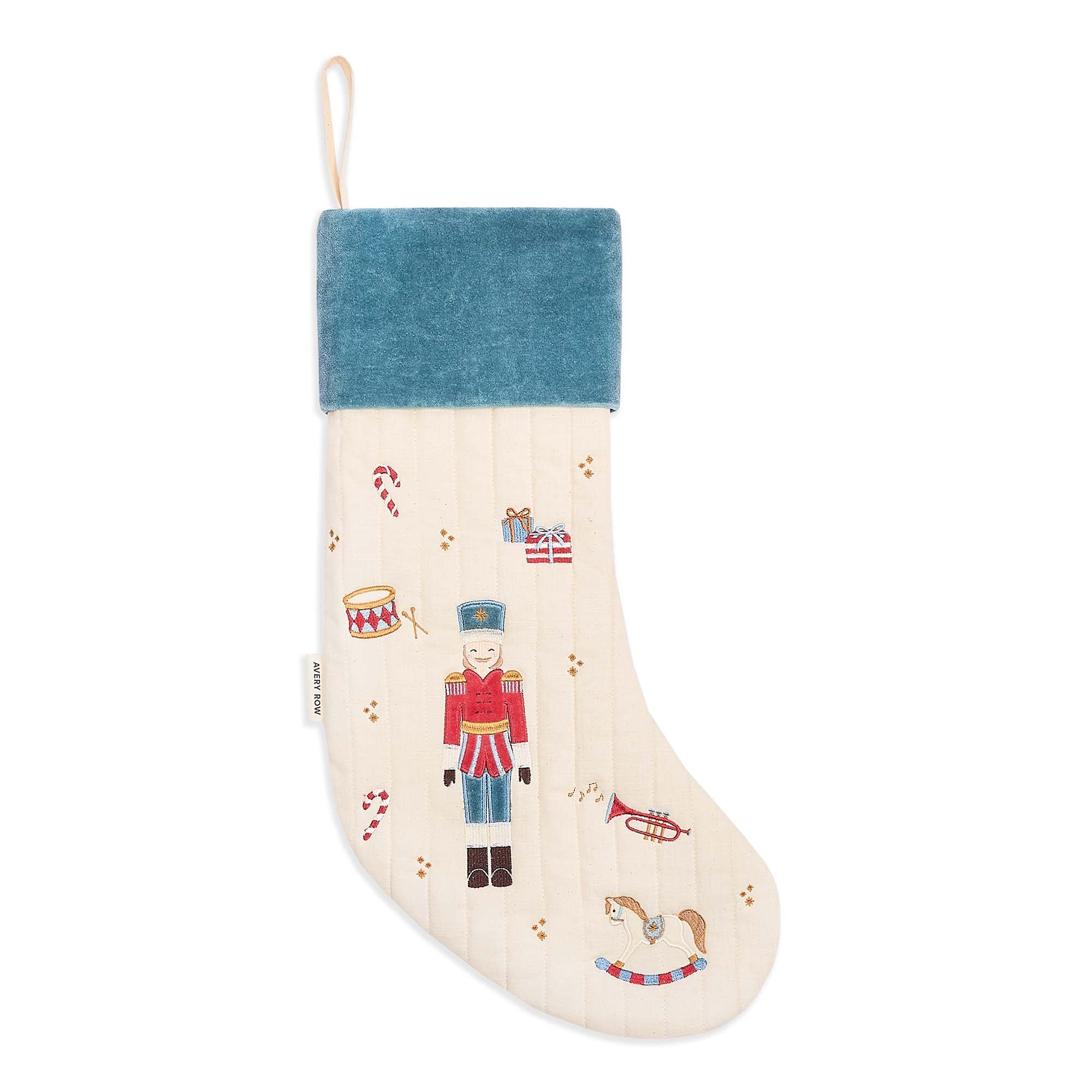 Decorative Christmas stocking with a blue top and festive designs on a white background
