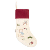 A Christmas stocking with a cream-colored body featuring embroidered teddy bears, birds, and trees, a dark red velvet cuff, and a hanging loop at the top.