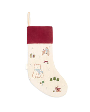 A Christmas stocking with a cream-colored body featuring embroidered teddy bears, birds, and trees, a dark red velvet cuff, and a hanging loop at the top.