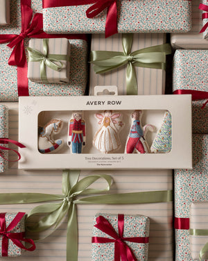 Avery Row Two Decorations Set of 5 in its original window box packaging, surrounded by wrapped Christmas gifts with red ribbons and green satin bows.