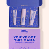 Bloom Blossom 'You've Got This Mama' pregnancy and new mum gift set, featuring an open blue box with three white and lavender skincare tubes, and a matching lavender gift card below on a light beige background.
