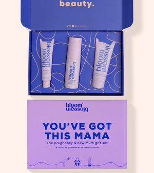 Bloom Blossom 'You've Got This Mama' pregnancy and new mum gift set, featuring an open blue box with three white and lavender skincare tubes, and a matching lavender gift card below on a light beige background.