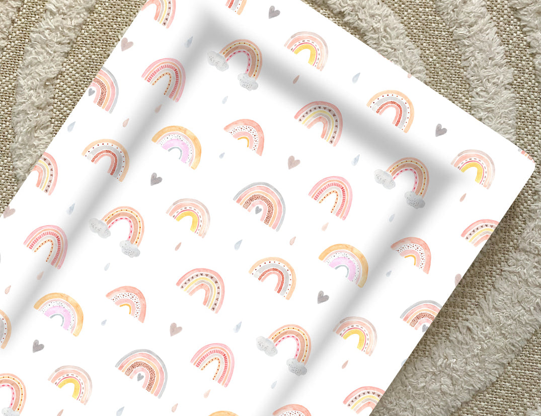 Standard Changing Mat Beau Rainbow Print seen from above on a cream textured rug, showing the raised edges