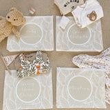 Hospital bag organiser pouches, beige leaf, four labelled pouches laid on carpet with baby clothes, muslin and a teddy