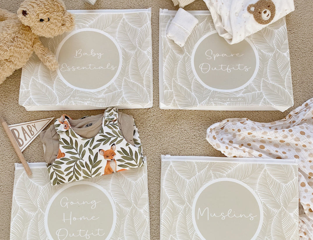 Hospital bag organiser pouches, beige leaf, four labelled pouches laid on carpet with baby clothes, muslin and a teddy