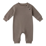 Waffle Long-Sleeve Baby All in One in brown laid flat, showing shoulder buttons, ribbed cuffs and leg poppers