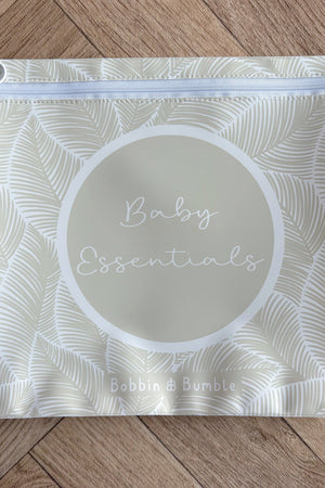 Hospital bag organiser pouches, beige leaf, flat pouch labelled Baby Essentials on a wooden floor