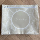 Hospital bag organiser pouches, beige leaf, flat pouch labelled Snacks on a wooden floor