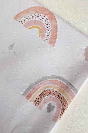 Splash Mat Beau Pink Rainbow Print, close-up of a folded corner showing pastel rainbows, hearts and raindrops on white