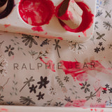 Floral-patterned product with 'RALPHIE BEAR' branding on a matching tray.