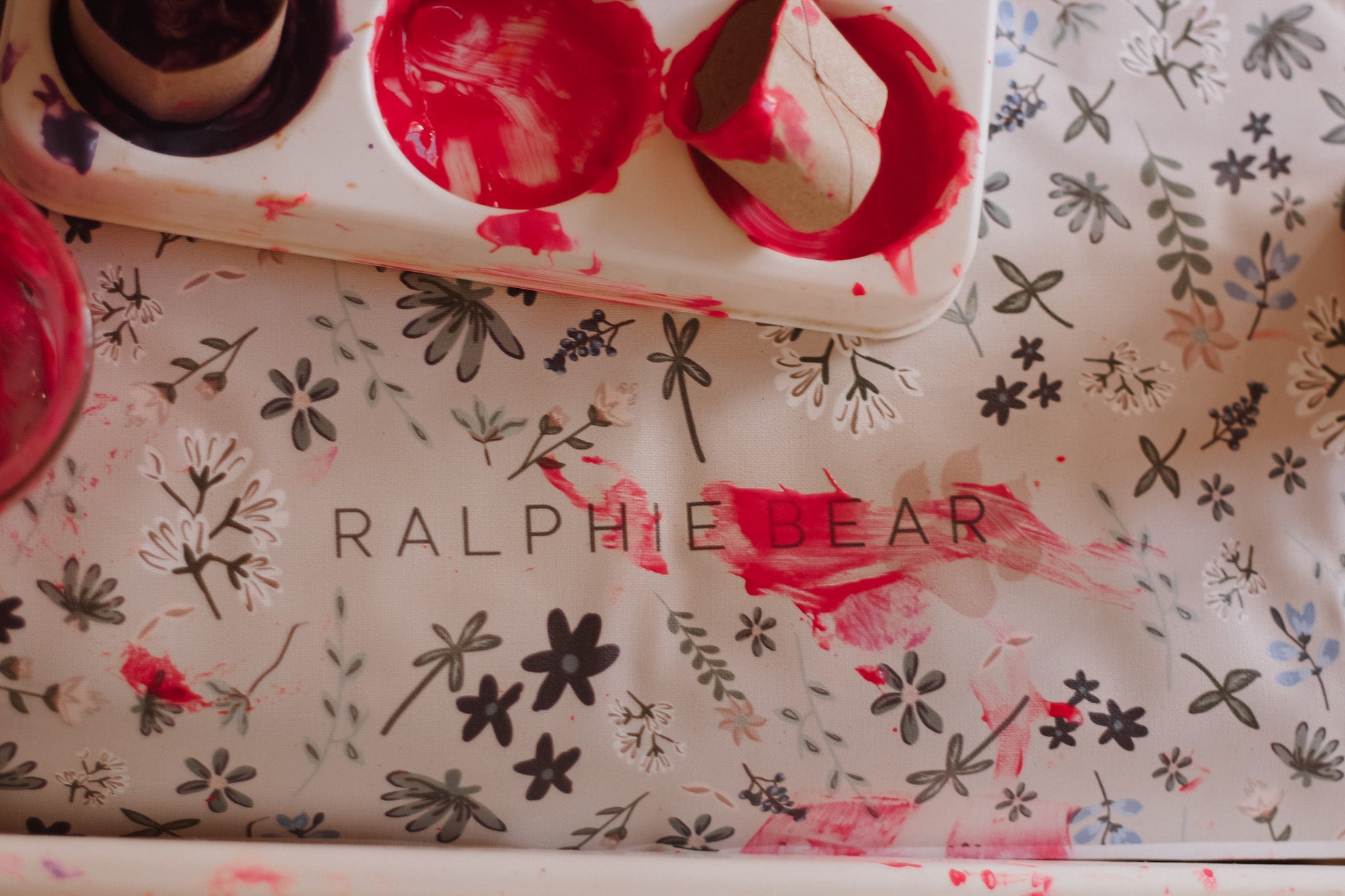 Floral-patterned product with 'RALPHIE BEAR' branding on a matching tray.