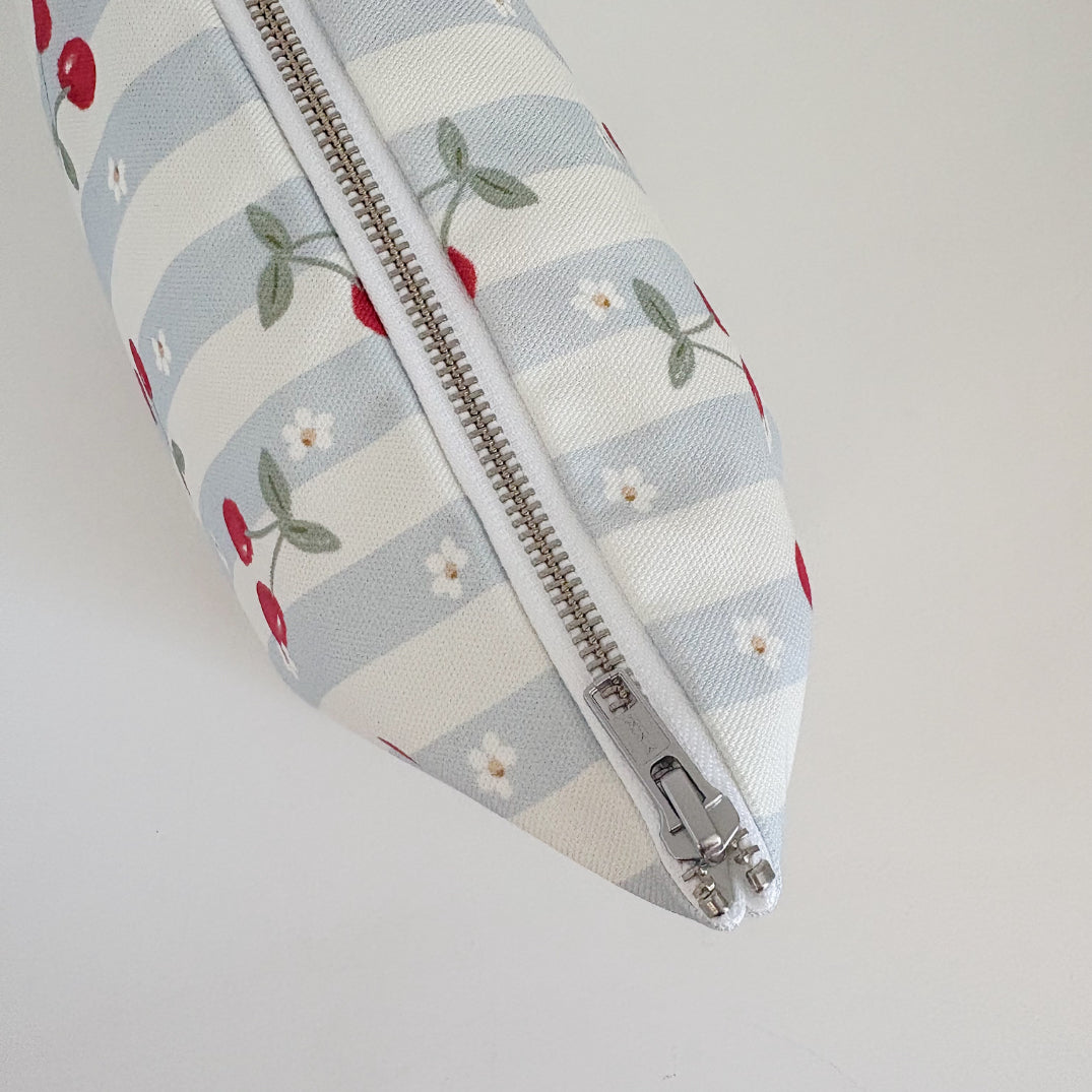Nappy Wallet Cherry Stripe, top-down close-up of the closed silver zip running along the striped fabric