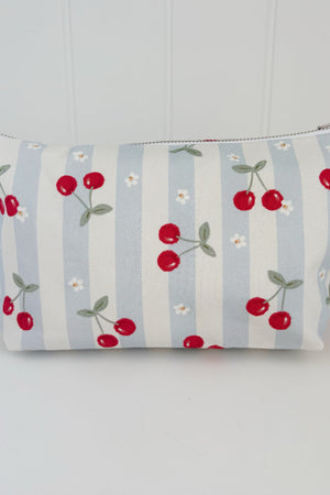 Nappy Wallet Cherry Stripe, front view of blue and cream striped zipped pouch with red cherries and small white flowers