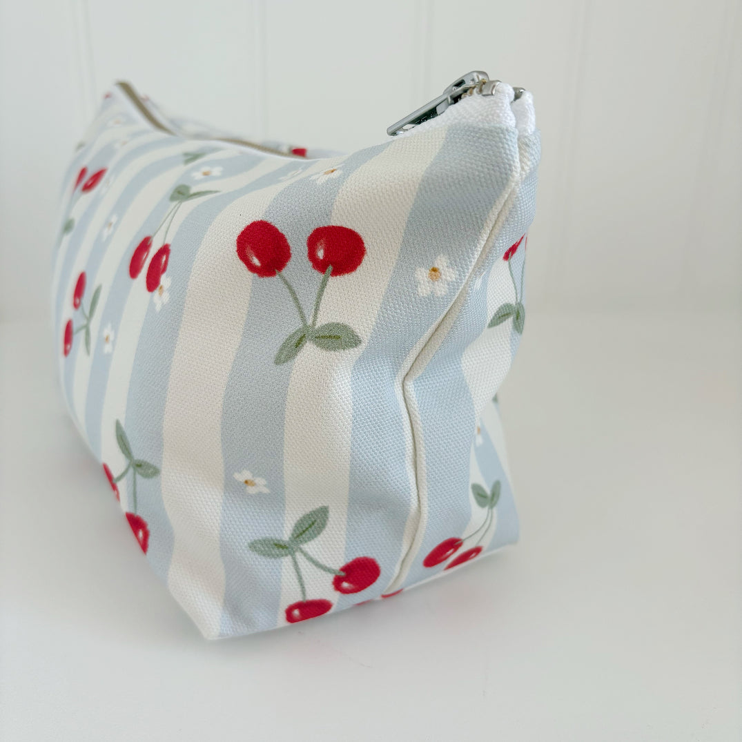 Nappy Wallet Cherry Stripe, side view showing the cherry print on the stripes and the zip end at the top