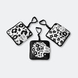 Set of three black and white patterned pouches on a light gray background