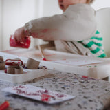 Child playing with craft materials on a table