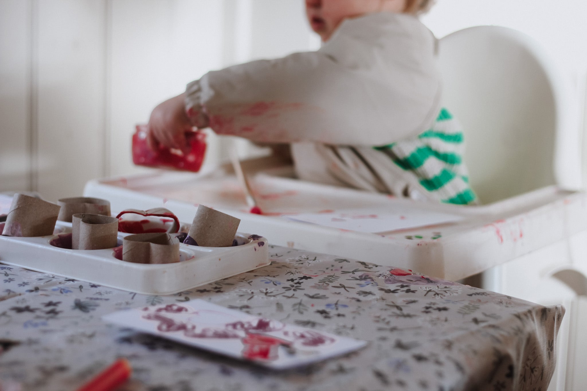 Child playing with craft materials on a table