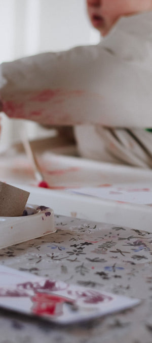 Child playing with craft materials on a table