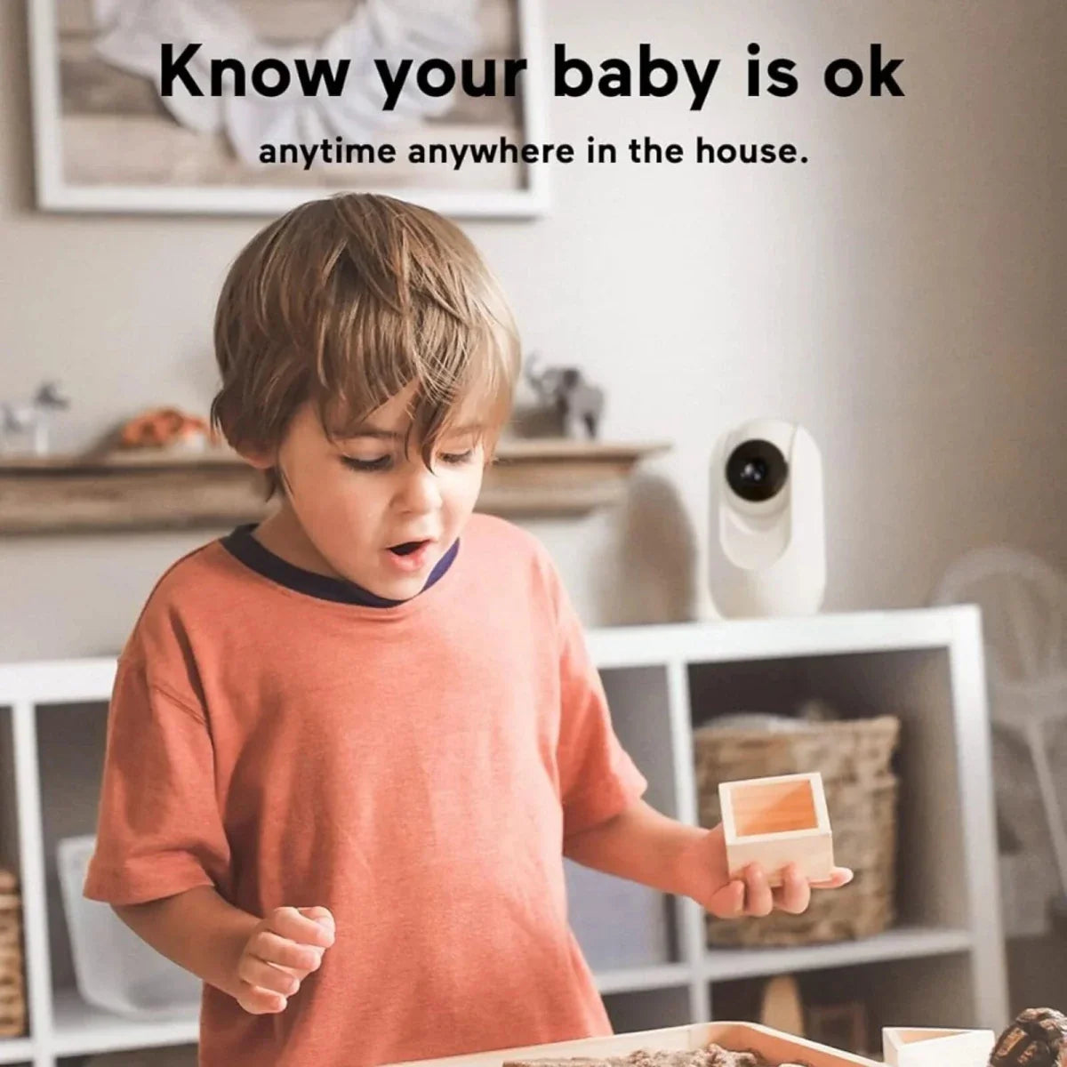 Child holding a small box with a security camera in the background, text 'Know your baby is ok anytime anywhere in the house'.