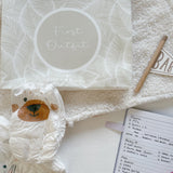 Hospital bag organiser pouches, beige leaf, First Outfit pouch with a nappy, hospital bag checklist notebook and pen