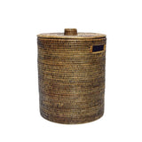 Handwoven Luxe Washing Hamper, a tall round woven basket with a lid and a cut-out side handle, on white