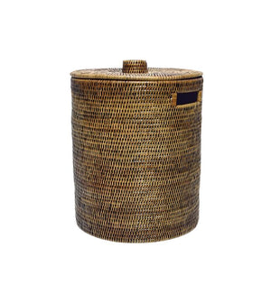 Handwoven Luxe Washing Hamper, a tall round woven basket with a lid and a cut-out side handle, on white