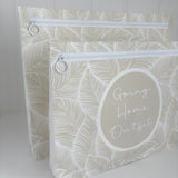 Hospital bag organiser pouches, beige leaf, two pouches standing side by side, front one labelled Going Home Outfit