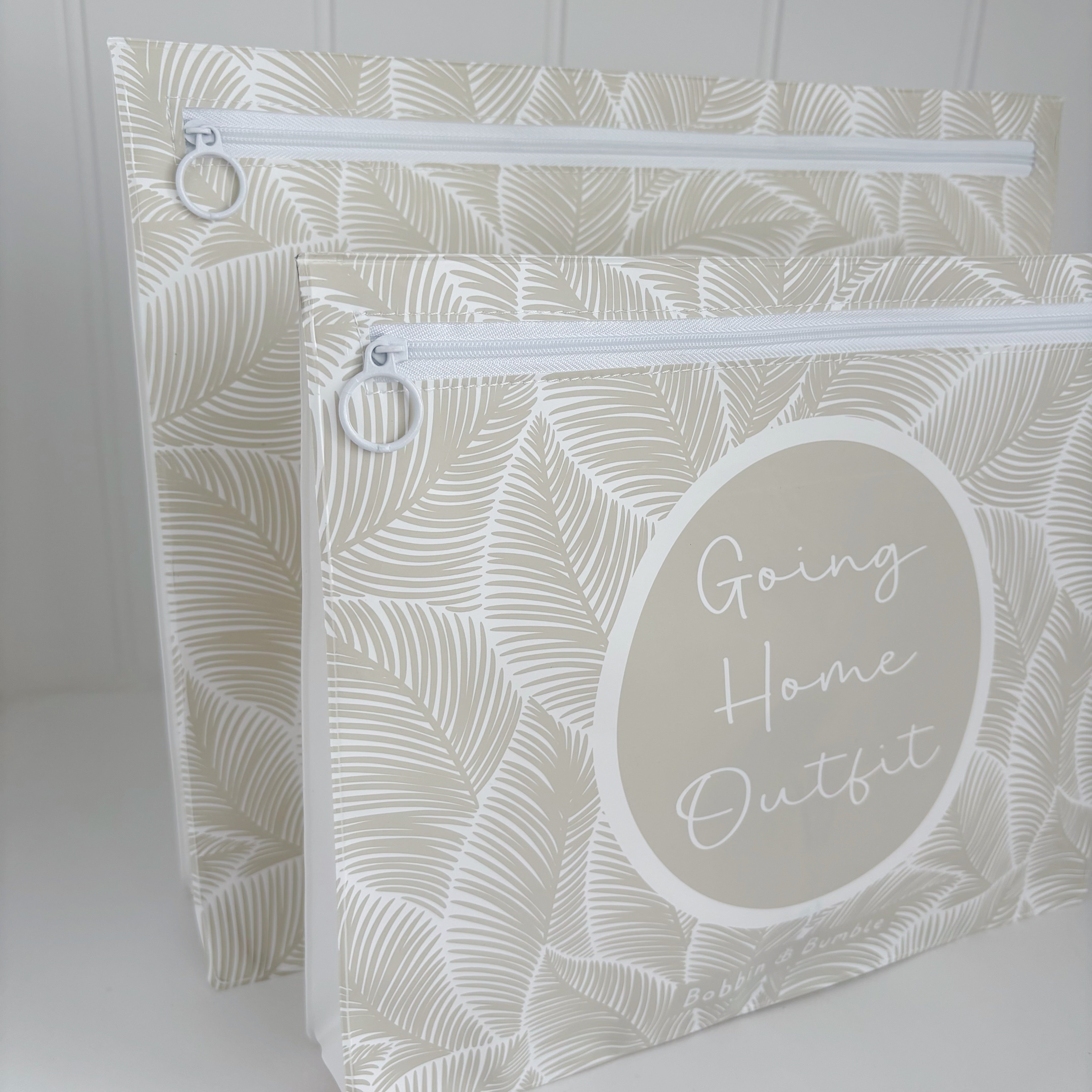 Hospital bag organiser pouches, beige leaf, two pouches standing side by side, front one labelled Going Home Outfit