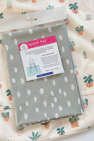 Splash Mat Sage Spots, in its packaging on a cream bib with a potted plant print