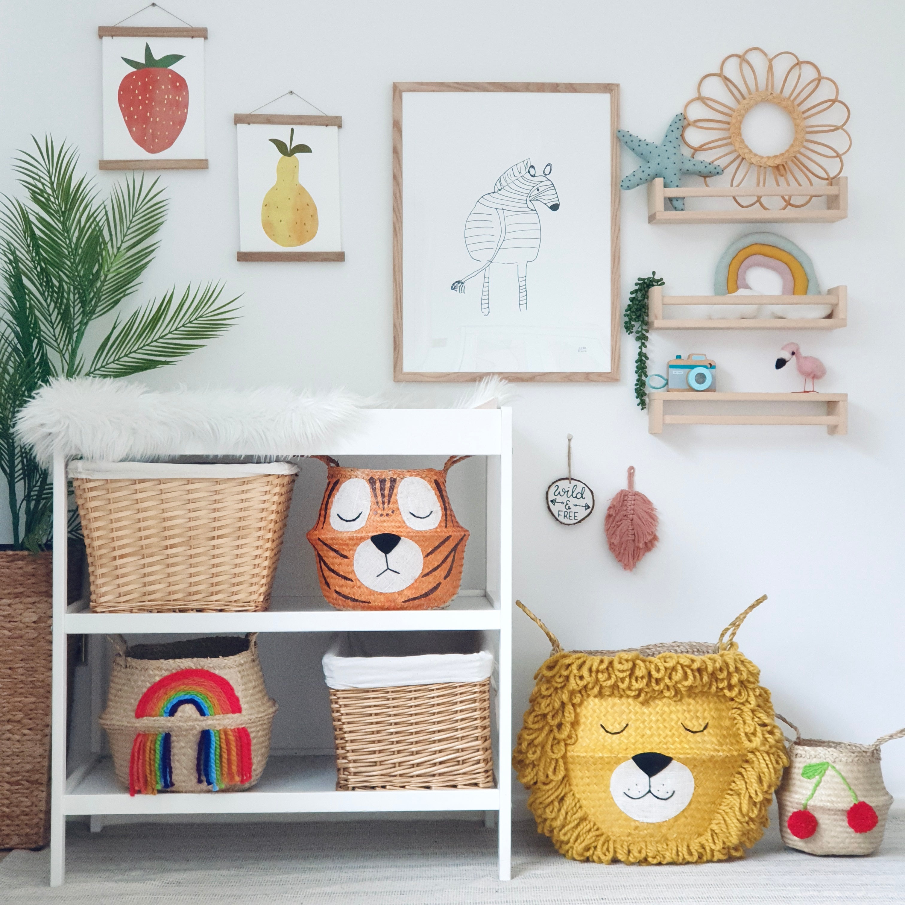 Vivid Rainbow Belly Basket on the bottom shelf of a white changing unit, beside animal baskets and wall art