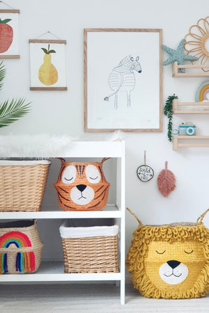 Vivid Rainbow Belly Basket on the bottom shelf of a white changing unit, beside animal baskets and wall art