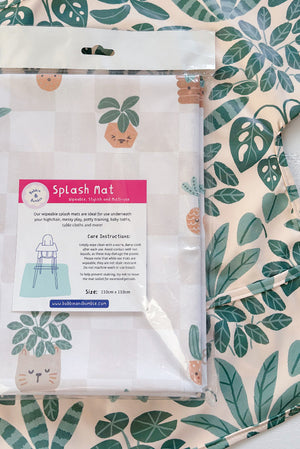 Splash Mat, Pot Plants: in its packaging laid on a matching leaf print long-sleeved bib