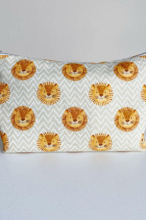 Nappy wallet in Leo lion print, front view of the zipped pouch with lion faces on a cream zigzag pattern