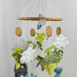 Little Dino Land felt cot mobile full view with hanging hook, wooden bead, slice-shaped discs and felt dinosaurs