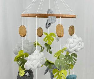 Little Dino Land felt cot mobile full view with hanging hook, wooden bead, slice-shaped discs and felt dinosaurs