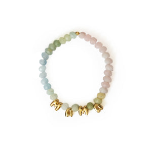 A beaded stretch bracelet featuring pastel green, light blue, and pale pink stones with gold letter charms spelling 'MAMA' on a white background.