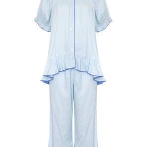 A light blue two-piece pajama set featuring a short-sleeve button-front top with ruffle details and matching wide-leg pants with ruffle hems, shown on a plain white background.