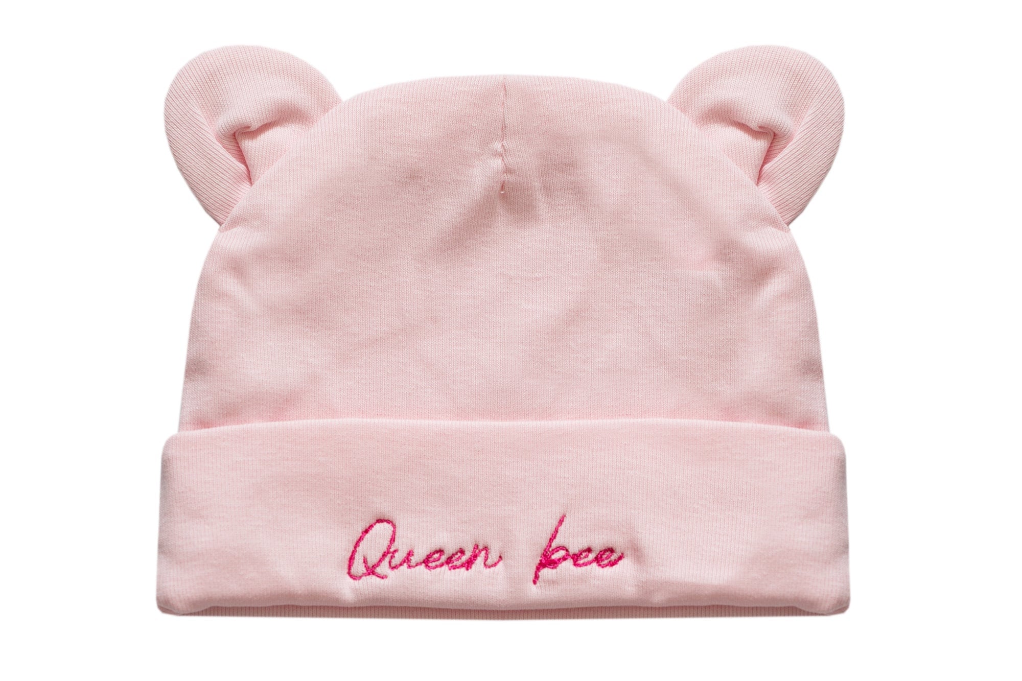 A light pink baby beanie hat with small bear ears on top and the words 'Queen bee' embroidered in pink script on the folded cuff, shown against a plain white background.