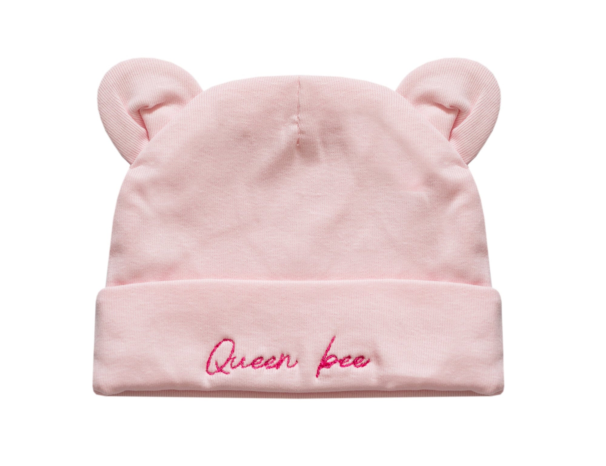 A light pink baby beanie hat with small bear ears on top and the words 'Queen bee' embroidered in pink script on the folded cuff, shown against a plain white background.