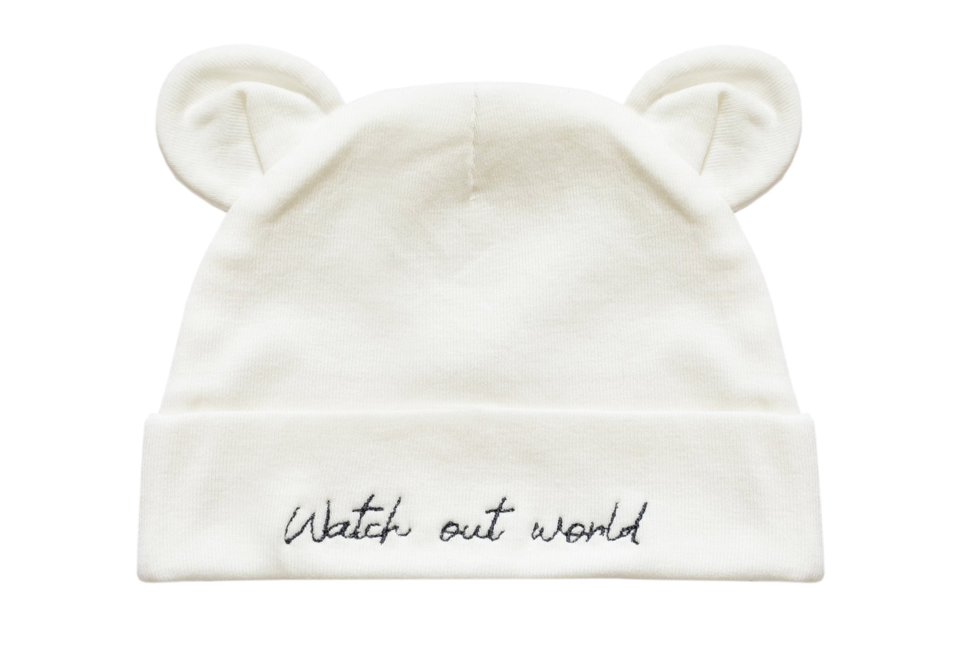 An off-white knit baby beanie hat featuring embroidered bear ears on top and the phrase 'Watch out world' in black script on the folded cuff.